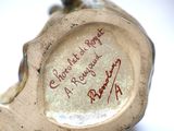 a close up of a vase with writing on it