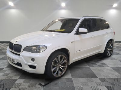 a picture of a white bmw suv parked on a checkered floor