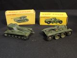 three toy army tanks are sitting next to each other on a black surface