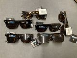 a lot of sunglasses that are sitting on a table