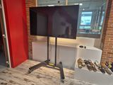 a flat screen tv sitting on a stand in a room