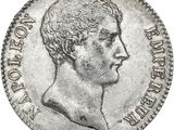 a close up of a coin with a man ' s head on it