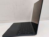a black laptop with a black keyboard on a white surface