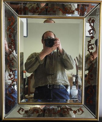 a man taking a picture of himself in a mirror