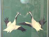 two birds that are standing in front of a window