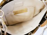 a person holding a purse with a chain around it