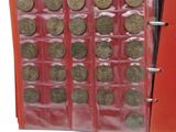a red binder with a bunch of coins in it