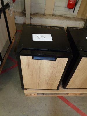 two black and wooden cabinets in a warehouse