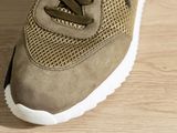 a close up of a person ' s shoe on a wooden floor