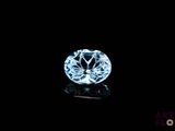 a close up of a blue diamond on a black surface