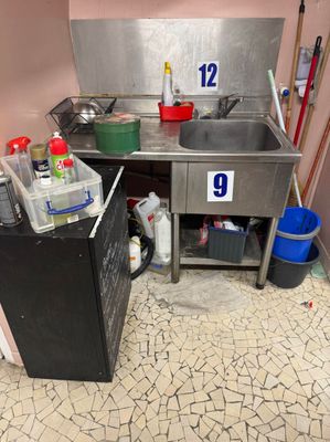a kitchen with a sink and a refrigerator in it