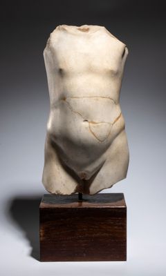 an image of a statue of a naked man on a wooden base