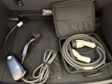 a car trunk with a charger and a cord in it