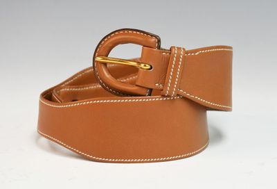 brown leather belt with white stitching and a gold buckle