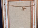 an old wooden easel with an empty canvas on a blue background