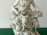 a statue of a man sitting on top of a pile of animals