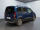 the blue van is parked in a large room with a black floor
