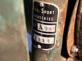 a close up of a rusted motorcycle with a sign on it