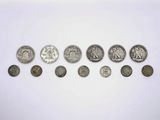 a group of coins sitting on top of a table next to each other