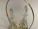 a silver and glass candle holder on a white table