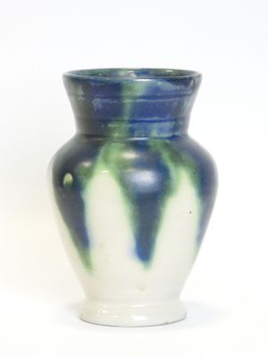 a blue and white vase sitting on a white surface