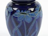 a blue vase with blue flowers on it on a white background
