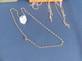 many different necklaces and bracelets on a table
