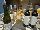 several bottles of wine are lined up on a table