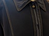 a close up of a mannequin wearing a black shirt and a black jacket