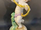 a figurine of a boy with a banana in his hand