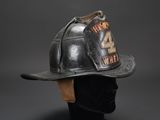 an old fireman ' s helmet with the number four on it