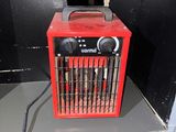 a red heater sitting on top of a shelf in a room