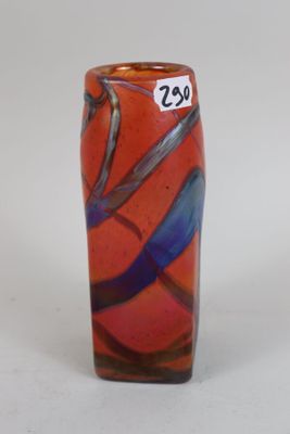 a glass vase with a design on it on a table