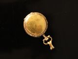 a close up of a gold locke on a black surface