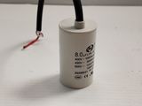 a close up of a capacitor on a white surface