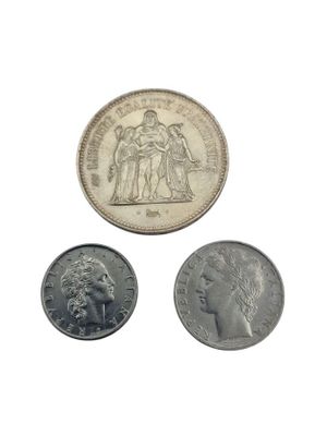 three coins are shown on a white surface with a white background