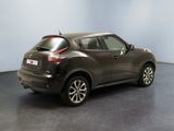 the rear end of a black nissan juke suv parked in a room