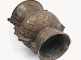 a large bronze vase on a white surface