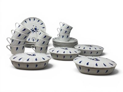 a lot of white and blue dishes and cups on the table