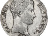 a close up of a coin with a woman ' s face on it