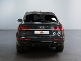 the rear end of a black audi suv parked in a white room