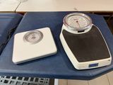 a scale and a clock sitting on a blue table