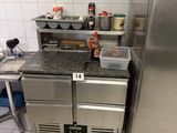 a kitchen with a refrigerator, stove, sink and counter top