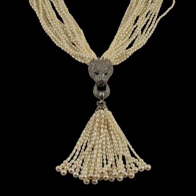 un gros plan d'un collier de perles sur fond noir