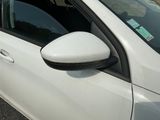 a white car that is parked on the side of the road