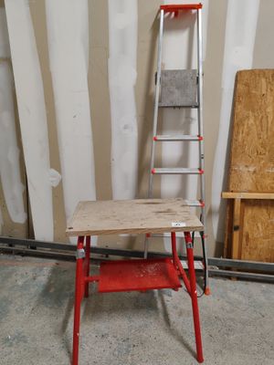 a red ladder leaning against a wall next to a table