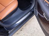 a close up of a car door with a brown leather seat