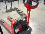 a forklift in a warehouse with lots of other equipment