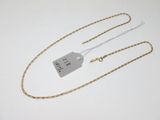 a close up of a gold chain with a tag on it