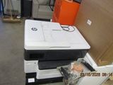 a printer sitting on top of a stack of boxes